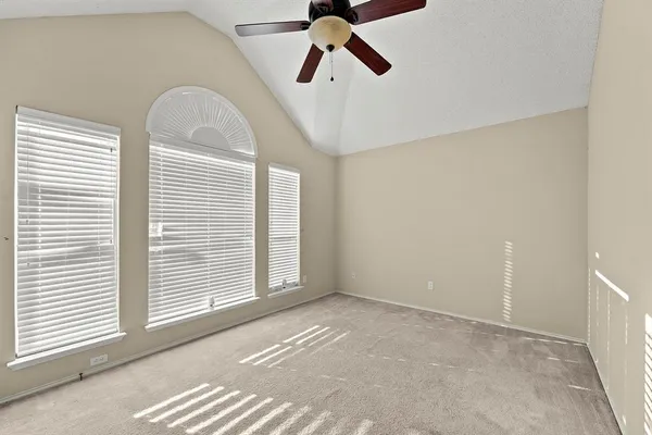 a view of a livingroom with a ceiling fan and window