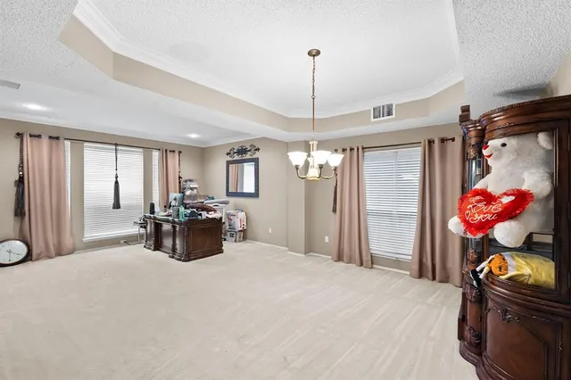 a bed room with a bed mirror and a chandelier