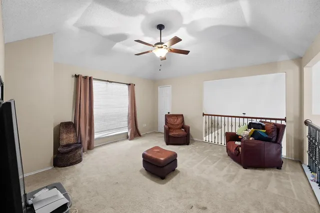 a room with furniture and a ceiling fan