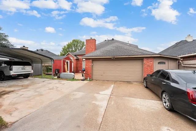 a front view of a house with a yard and parking space