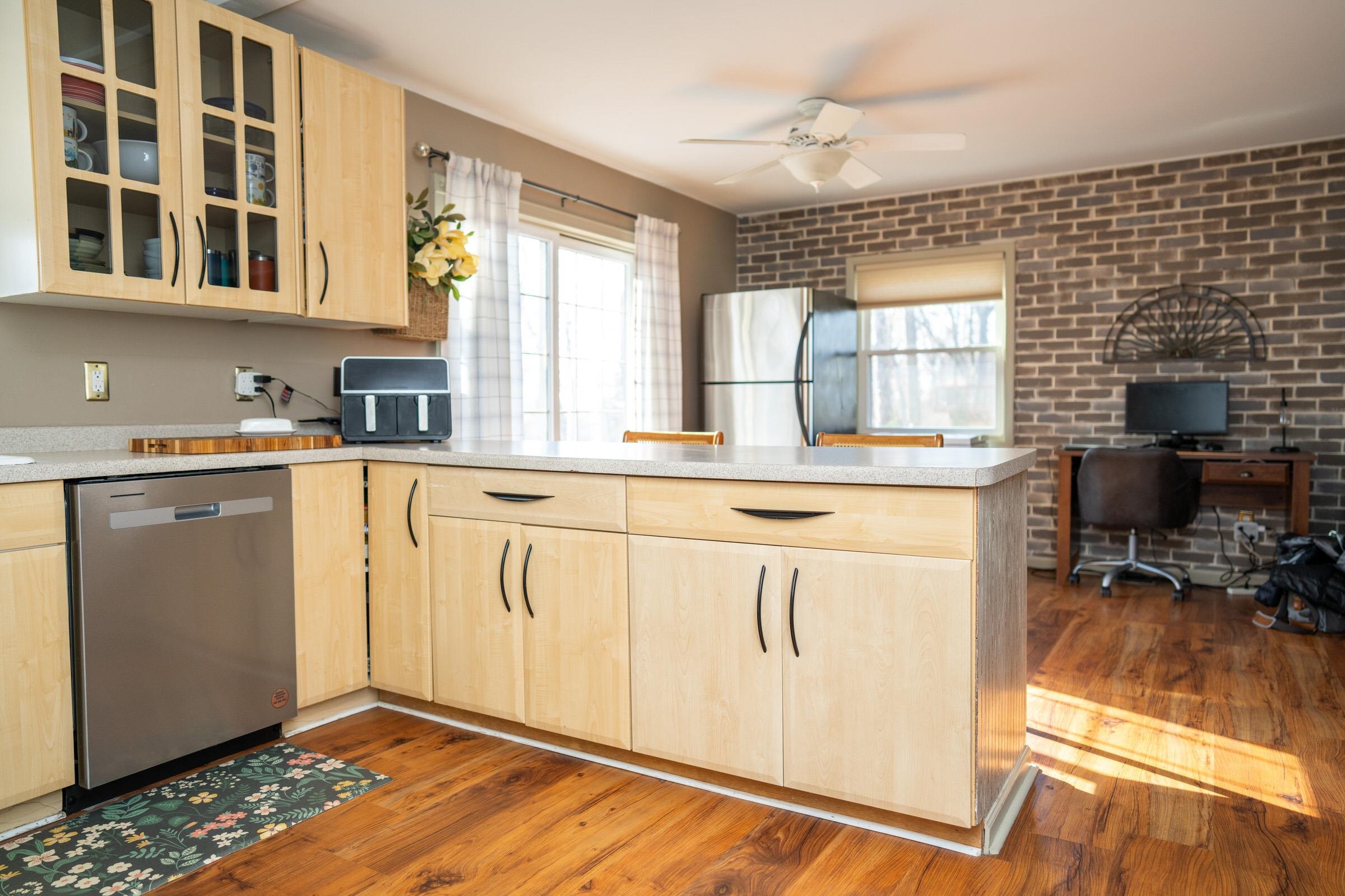 237 Rochester Road Northeast Poplar Grove, IL 61065 - Photo 11 of 28 a kitchen with stainless steel appliances granite countertop a stove a sink and a refrigerator