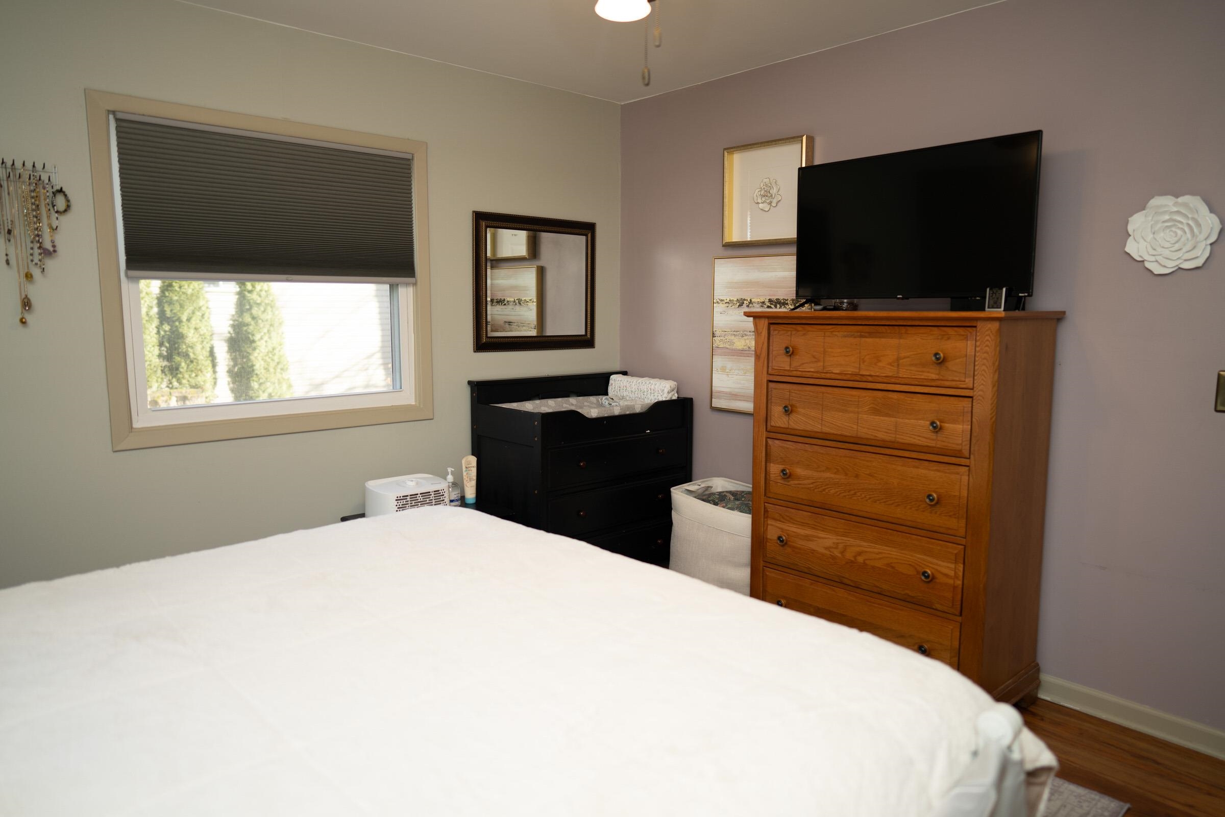 237 Rochester Road Northeast Poplar Grove, IL 61065 - Photo 14 of 28 a bedroom with a bed and a flat screen tv