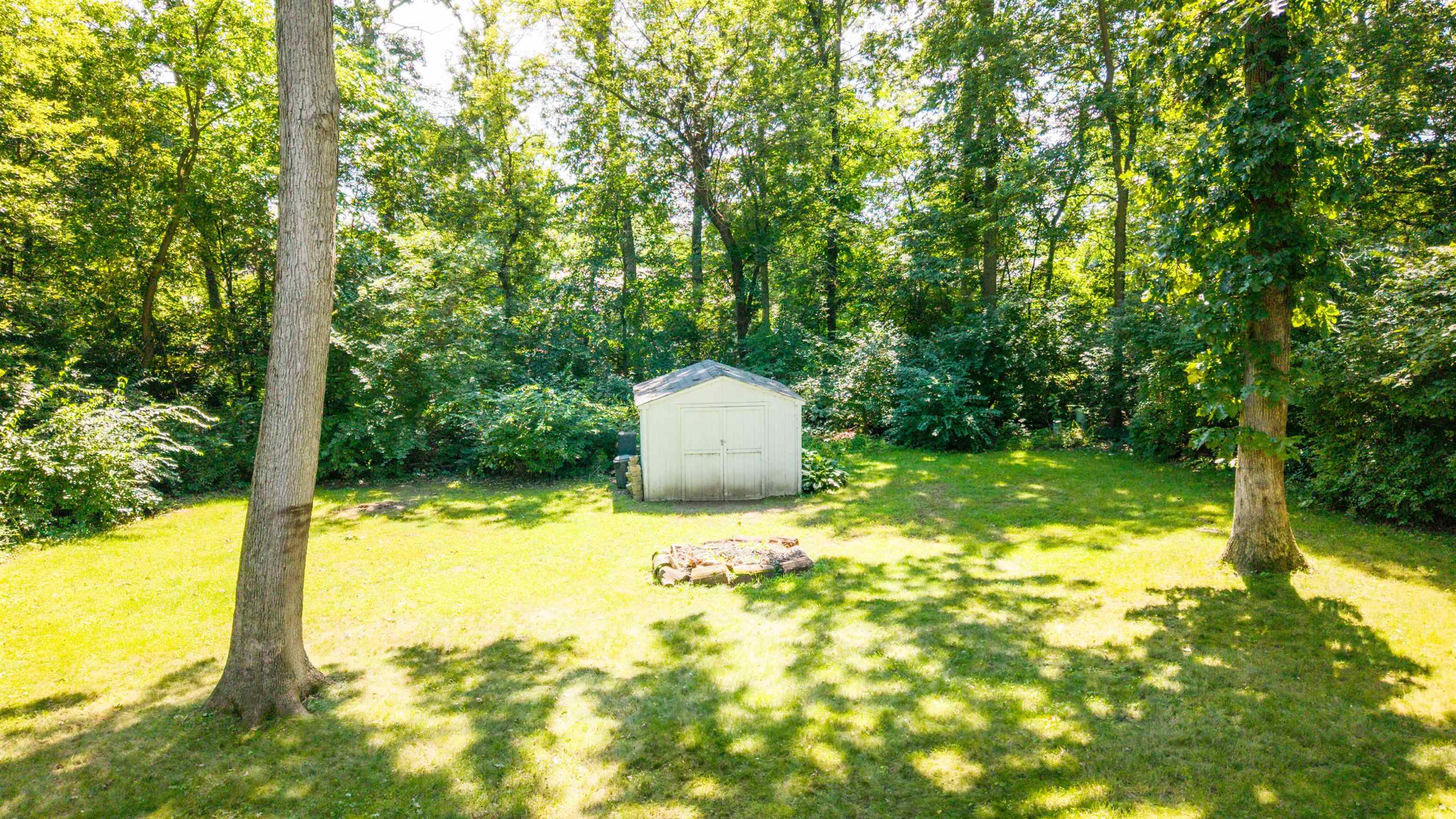 237 Rochester Road Northeast Poplar Grove, IL 61065 - Photo 5 of 28 a backyard of a house with a yard and outdoor seating