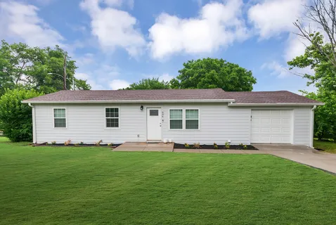 a front view of house with yard and green space
