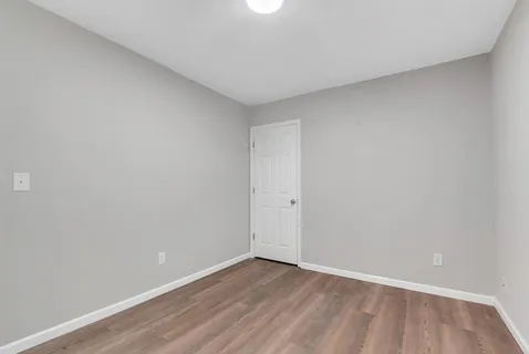 a view of an empty room and wooden floor
