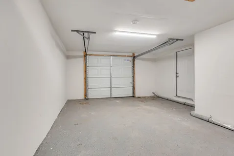 an empty room with closet and a ceiling fan