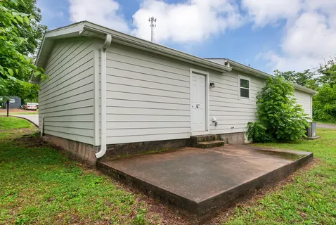 a view of a house with a backyard