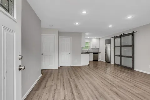 a view of empty room with wooden floor