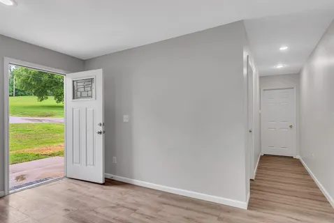 a view of livingroom with hardwood floor and a floor to ceiling window
