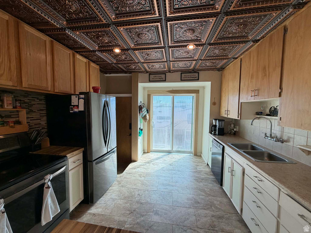 156 D Street Helper, UT 84526 - Photo 12 of 24 Kitchen with tasteful backsplash, stainless steel appliances, light countertops, open shelves, and an ornate ceiling