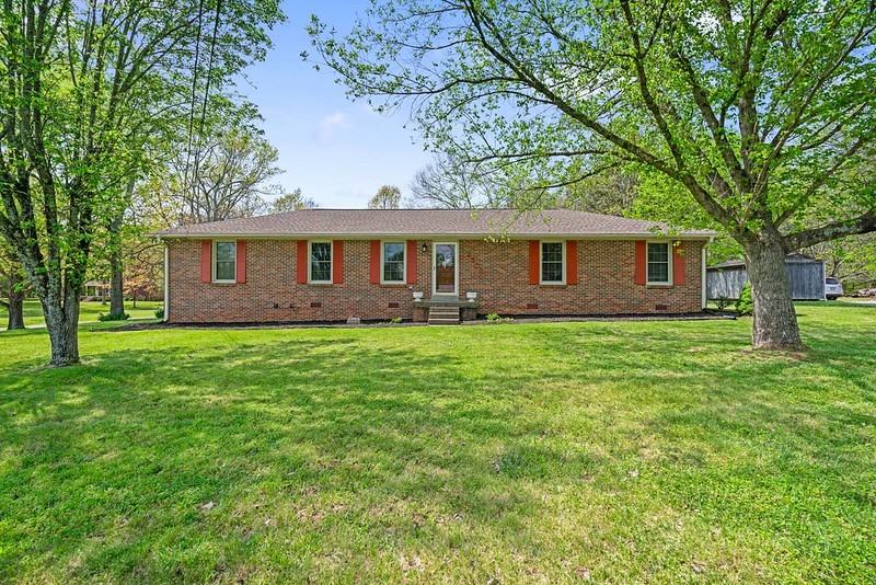 a front view of house with yard and green space