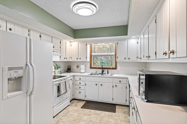 2300 Raspberry Lane Lebanon, TN 37087 - Photo 12 of 48 a kitchen with white cabinets and white appliances