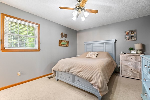 2300 Raspberry Lane Lebanon, TN 37087 - Photo 21 of 48 a bedroom with a bed and a chandelier