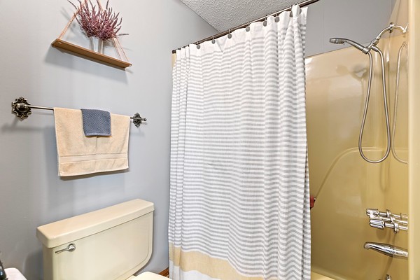 2300 Raspberry Lane Lebanon, TN 37087 - Photo 31 of 48 a bathroom with a white toilet and a shower curtain