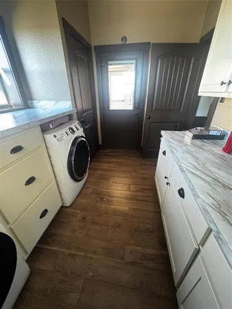 a view of a hallway with washer and dryer