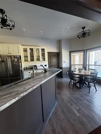 a living room with stainless steel appliances granite countertop furniture and a kitchen counter space