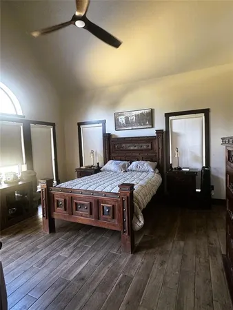 a bedroom with a bed and wooden floor