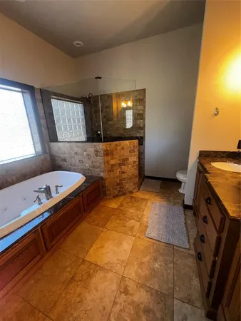 a bathroom with a sink mirror and a bath tub