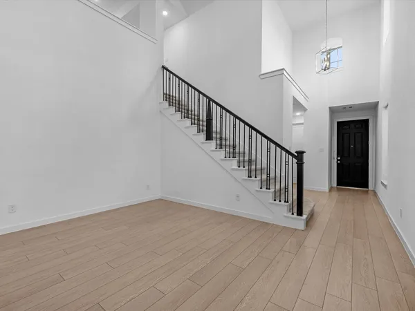 a view of a hallway with wooden floor and entryway