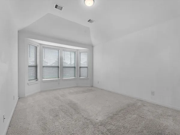 an empty room with a empty space and windows