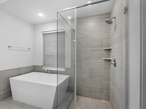 a bathroom with a bathtub and shower