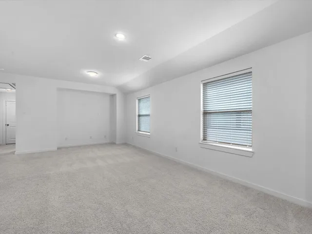 a bathroom with a sink double vanity granite tub and a mirror
