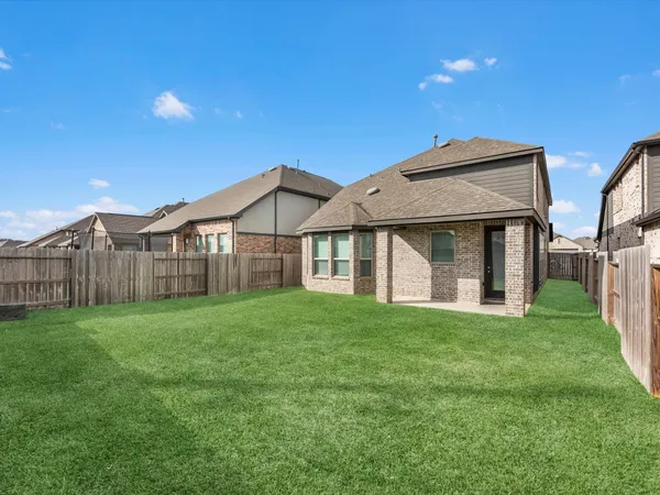 a view of backyard with wooden fence