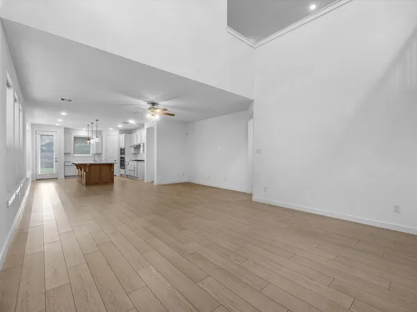 a view of empty room with wooden floor
