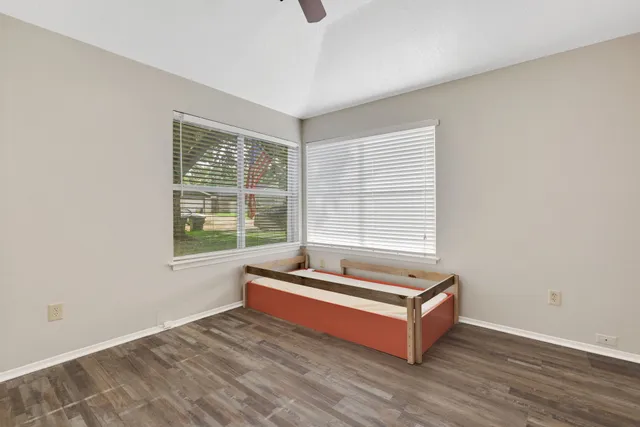 a room with a bed and window