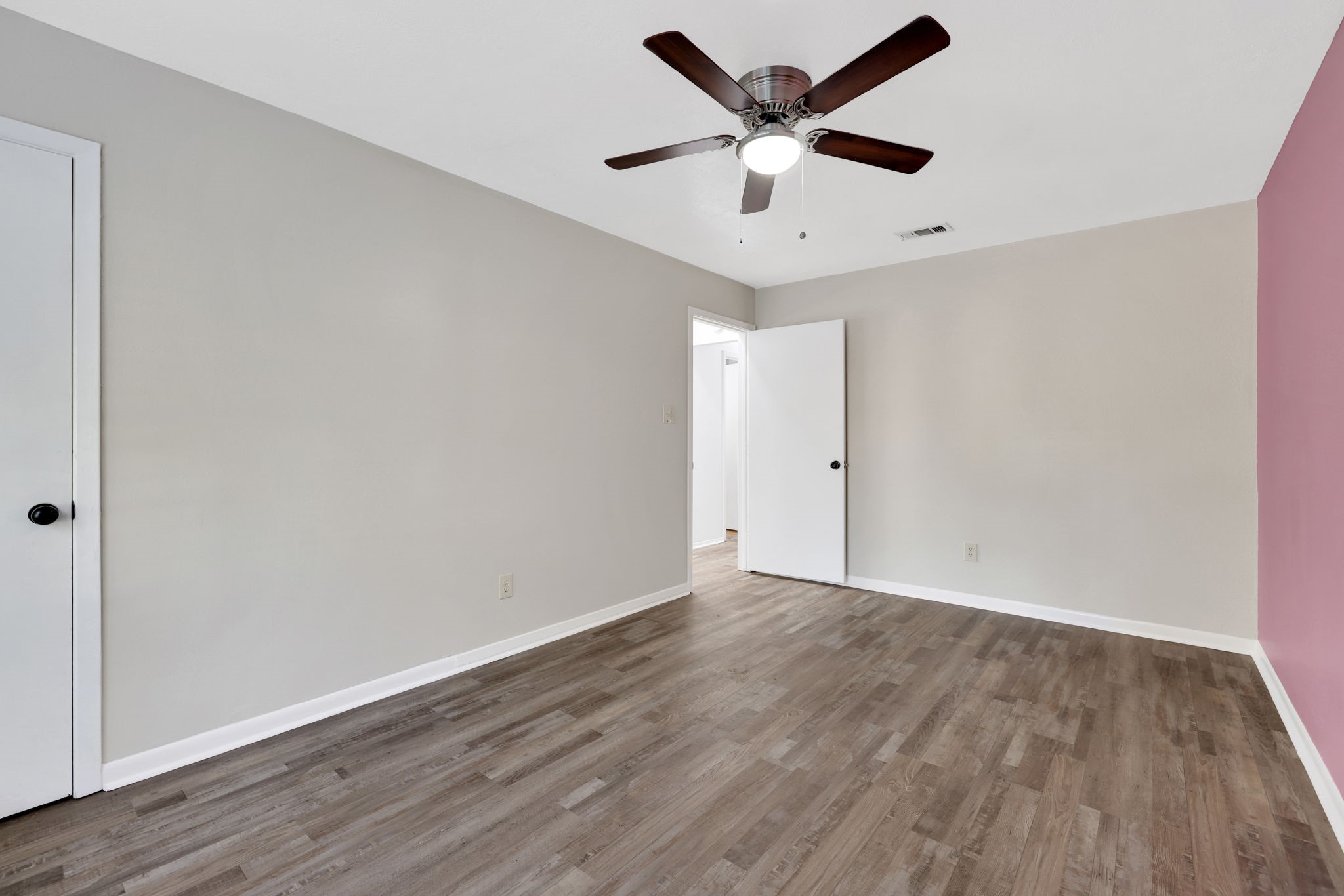 109 Jessica Street Liberty, TX 77575 - Photo 16 of 21 an empty room with wooden floor and ceiling fan