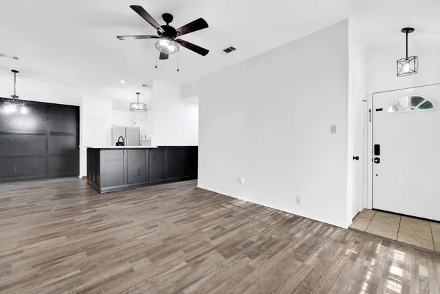 a view of a kitchen with a sink and a refrigerator