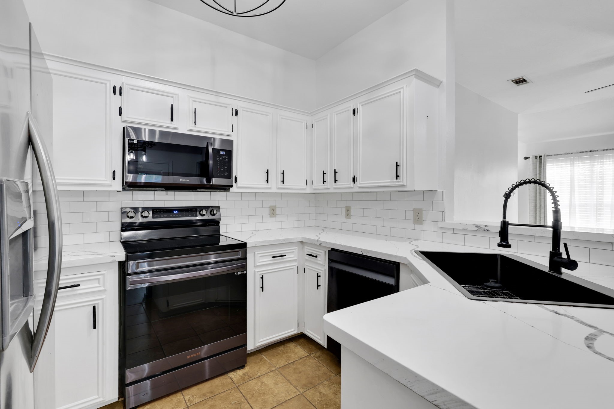 109 Jessica Street Liberty, TX 77575 - Photo 6 of 21 a kitchen with white cabinets stainless steel appliances and sink