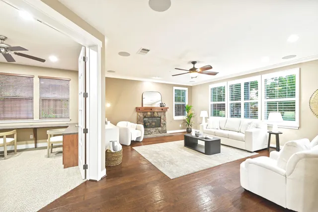 a living room with fireplace furniture and a large window