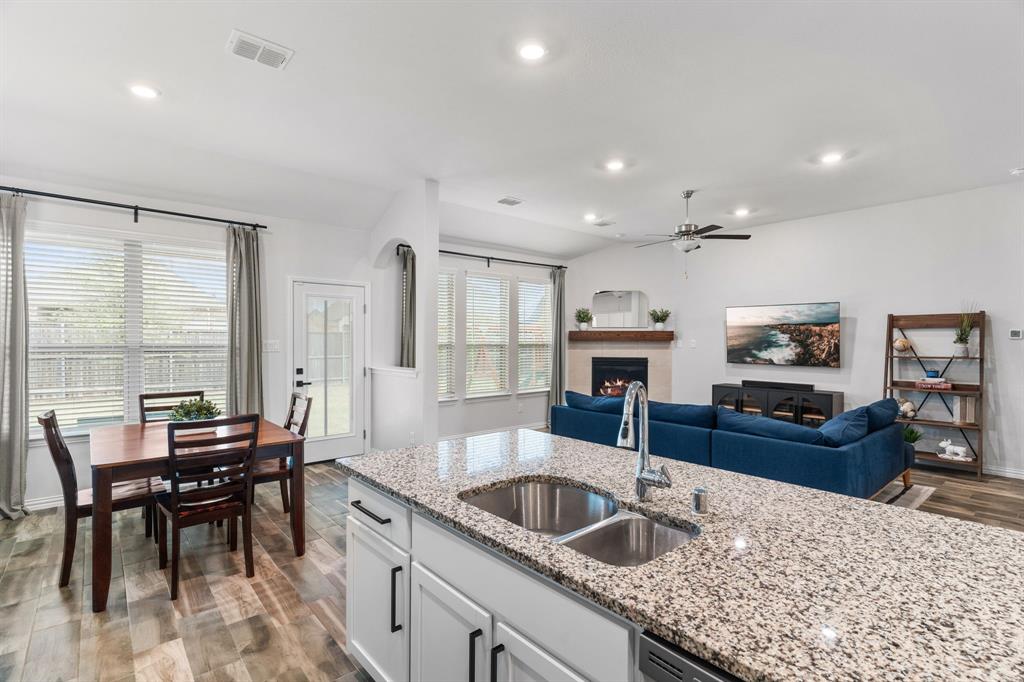 4324 Coffee Mill Road Celina, TX 75078 - Photo 14 of 38 a kitchen with granite countertop a sink and a refrigerator