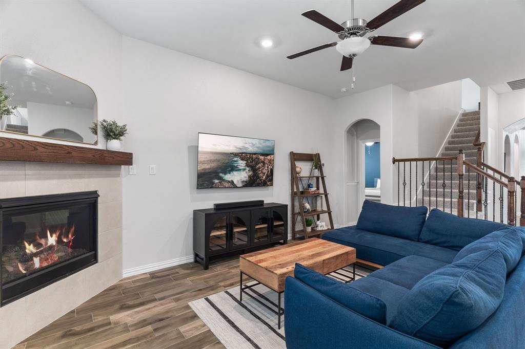 4324 Coffee Mill Road Celina, TX 75078 - Photo 17 of 38 a living room with furniture a flat screen tv and a fireplace