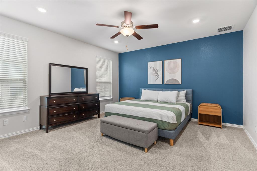 4324 Coffee Mill Road Celina, TX 75078 - Photo 18 of 38 a bedroom with a bed and a flat screen tv