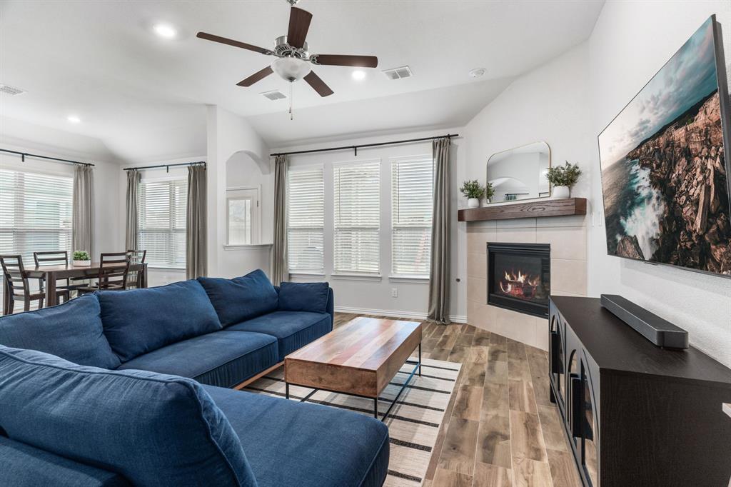 4324 Coffee Mill Road Celina, TX 75078 - Photo 2 of 38 a living room with furniture and a fireplace