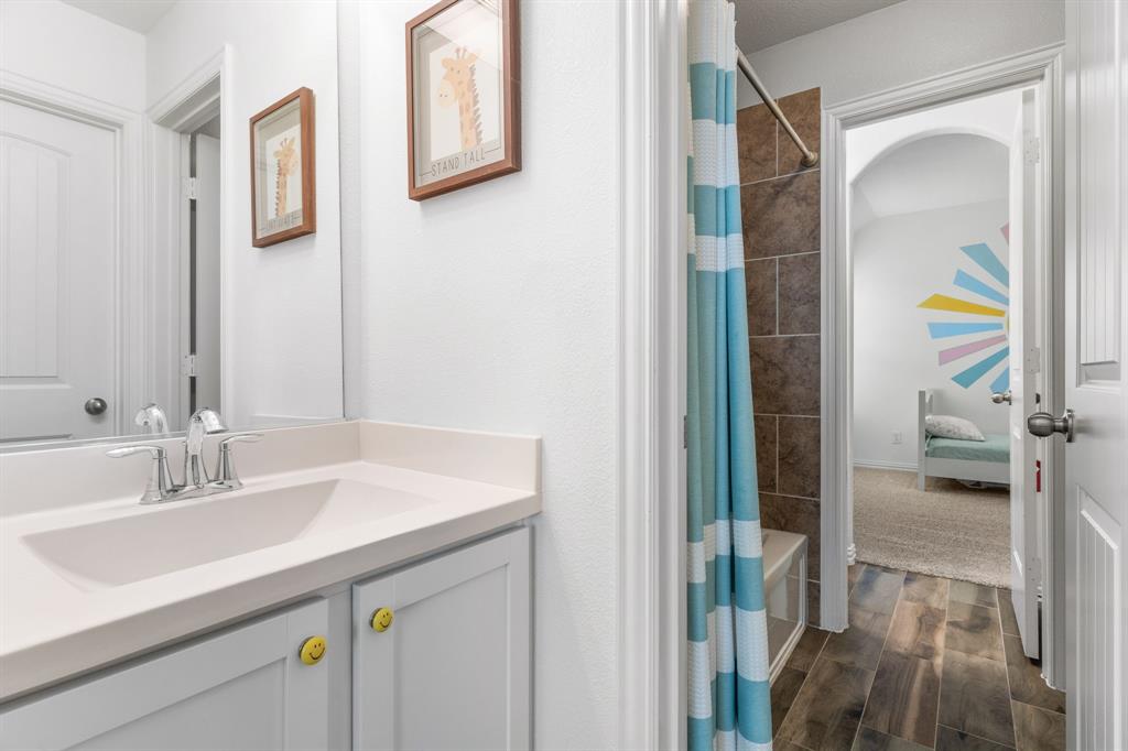 4324 Coffee Mill Road Celina, TX 75078 - Photo 29 of 38 a bathroom with a sink and a mirror