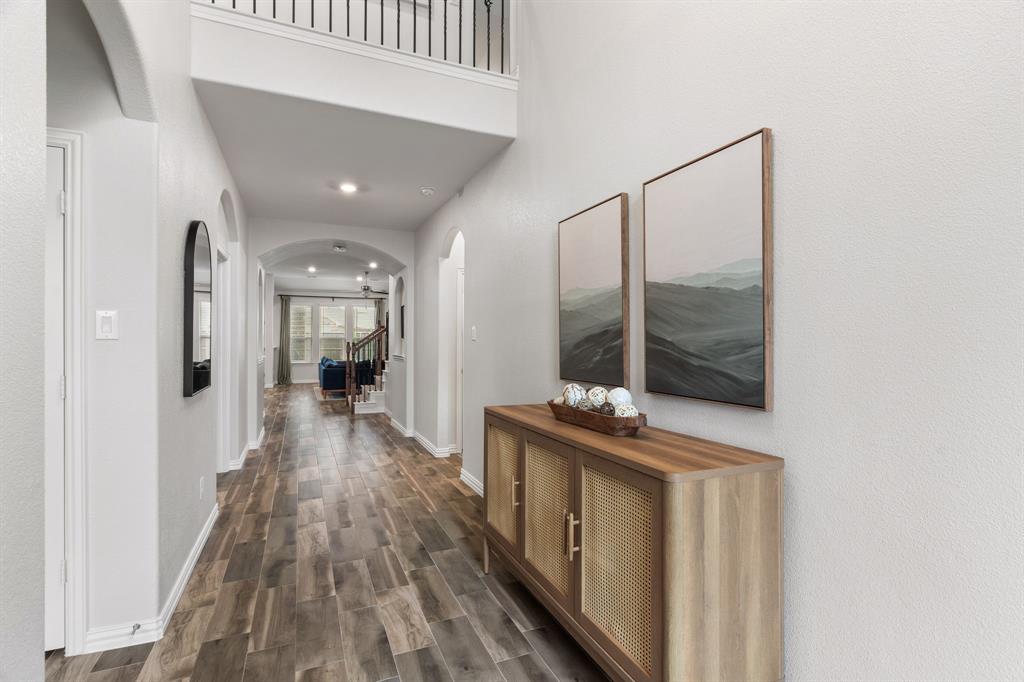 4324 Coffee Mill Road Celina, TX 75078 - Photo 6 of 38 a hallway with white cabinets and wooden floor
