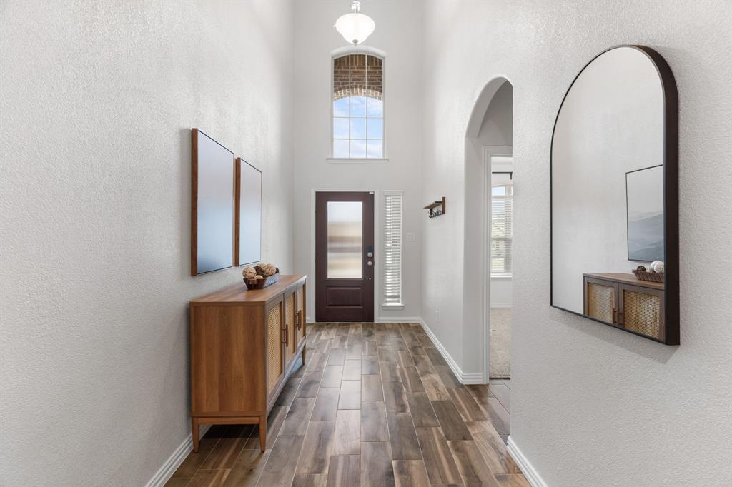 4324 Coffee Mill Road Celina, TX 75078 - Photo 7 of 38 a view of a hallway with wooden floor and staircase
