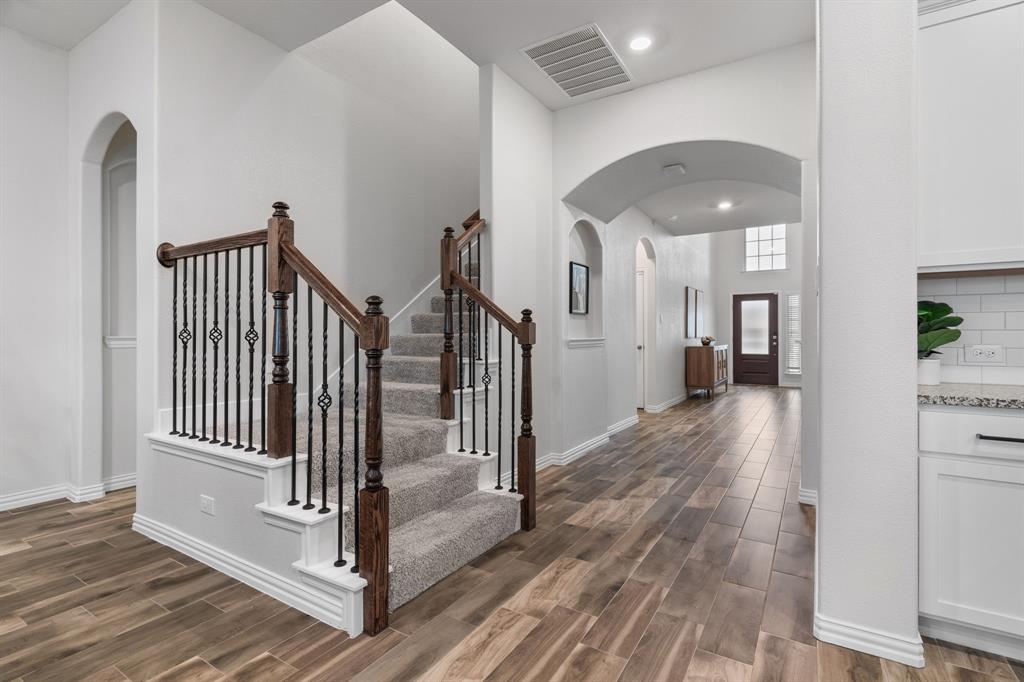 4324 Coffee Mill Road Celina, TX 75078 - Photo 10 of 38 a view of a hallway with a door and wooden floor