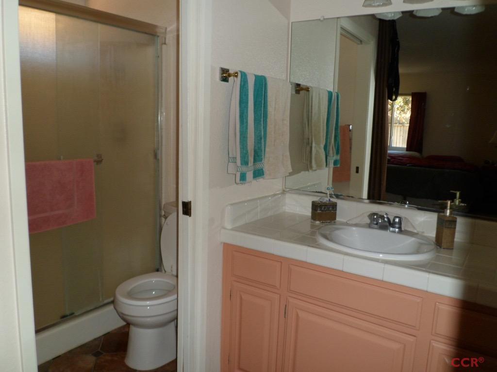 1434 Roper Way Santa Maria, CA 93455 - Photo 11 of 18 a bathroom with a granite countertop sink toilet and mirror