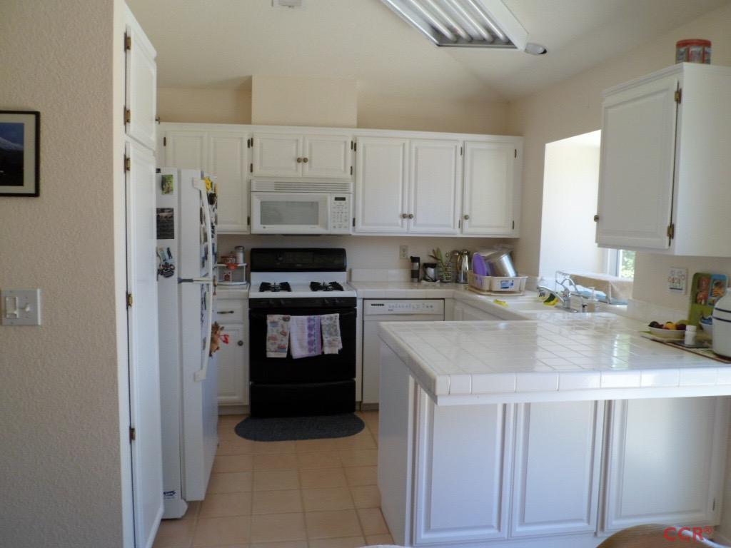 1434 Roper Way Santa Maria, CA 93455 - Photo 5 of 18 a kitchen with stainless steel appliances granite countertop a refrigerator sink and stove
