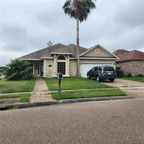 a front view of a house with a yard and entertaining space