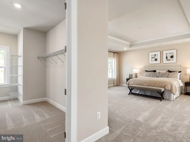 a spacious bedroom with a bed and a window