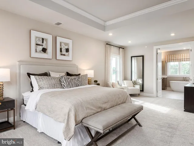 a spacious bedroom with a bed and glass window