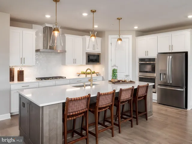 a kitchen with a table a refrigerator a cabinets and a dining table