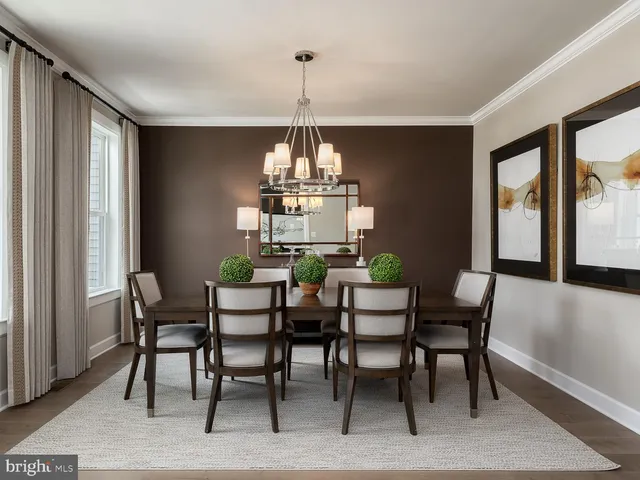 a dining room with furniture a chandelier and wooden floor