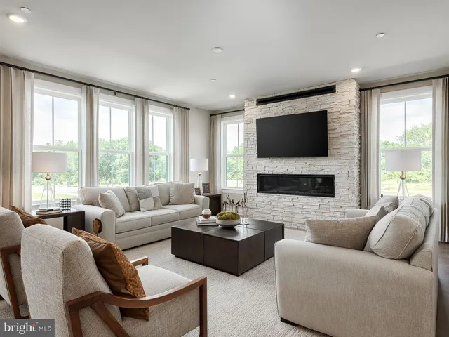 a living room with furniture a large window and a flat screen tv