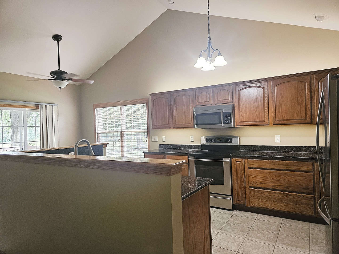 1670 Overlook Drive Dixon, IL 61021 - Photo 3 of 36 a kitchen with stainless steel appliances granite countertop a sink a stove and a wooden floors